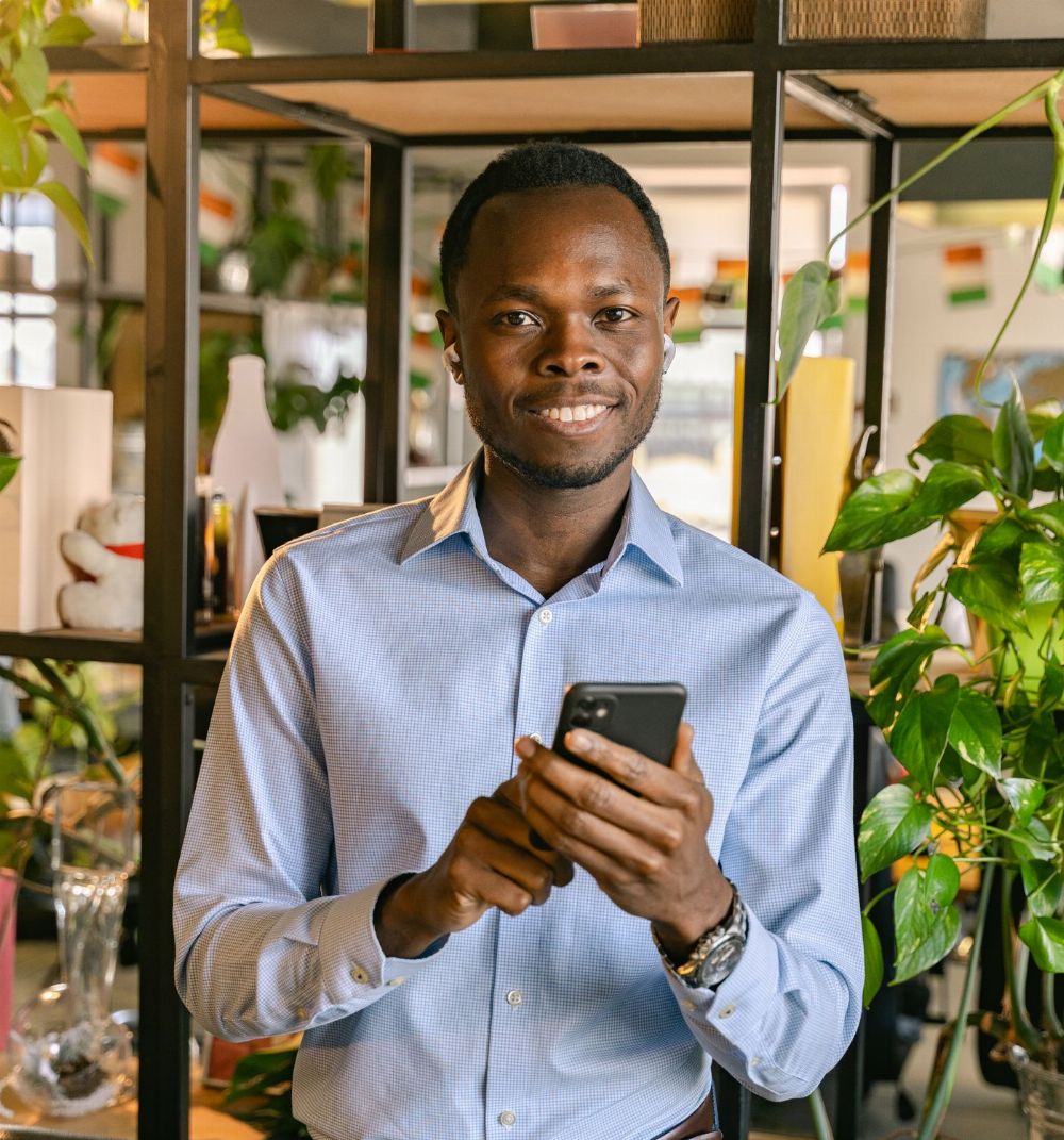Smiling man using his phone